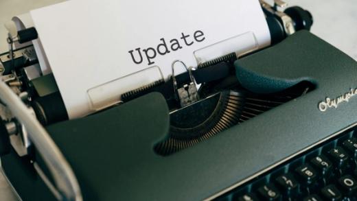 A vintage typewriter with the word "Update" typed on a sheet of paper.