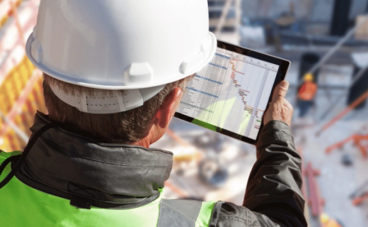 Construction worker Technology Mobile App in hand