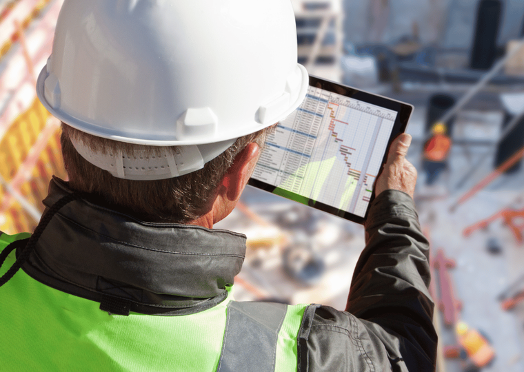 Construction worker Technology Mobile App in hand