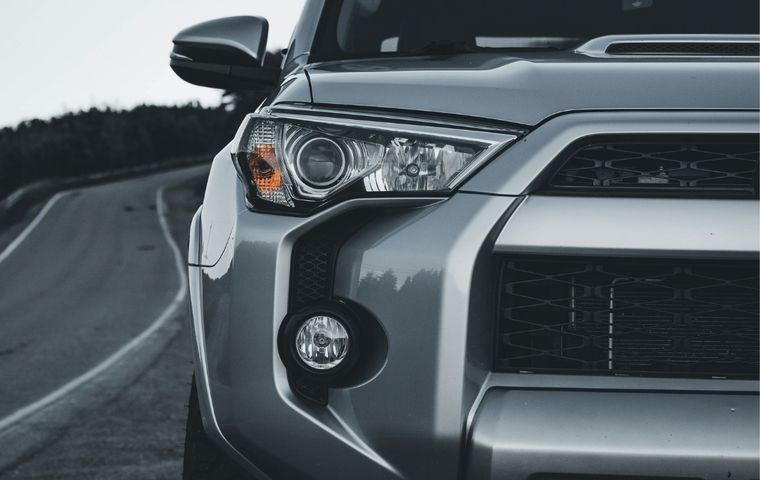 TEVPRO logo and the front of a silver SUV on a winding road.