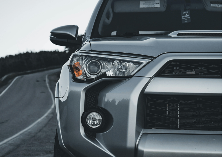TEVPRO logo and the front of a silver SUV on a winding road.