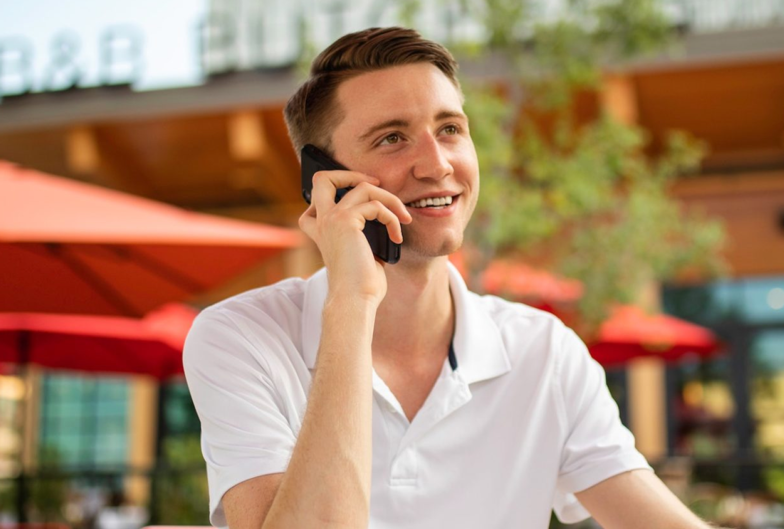 Man speaking on the phone outdoors