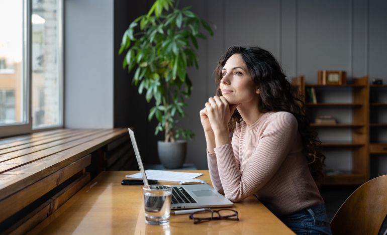 Woman thinking about how AI helps with social media moderation