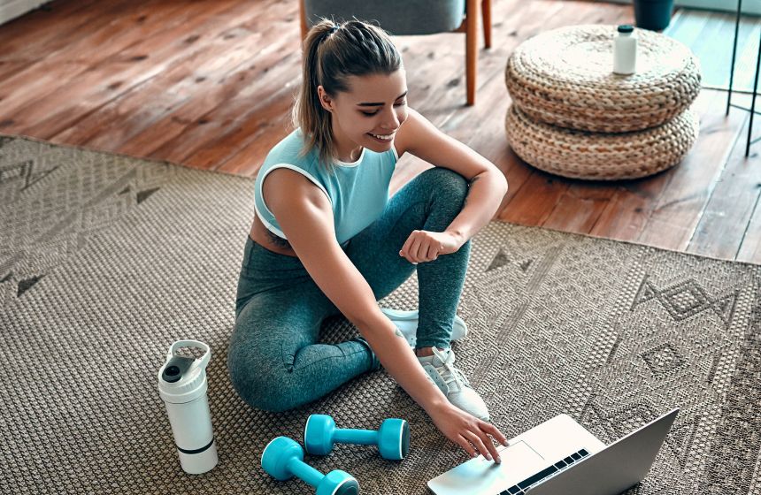 Woman in workout gear on her laptop 