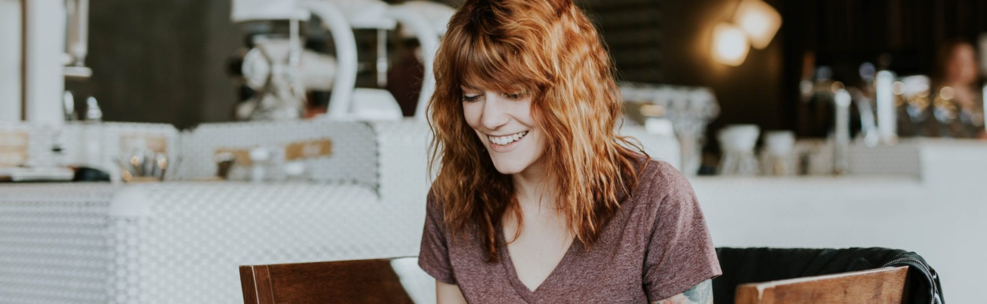 Woman smiling at a laptop