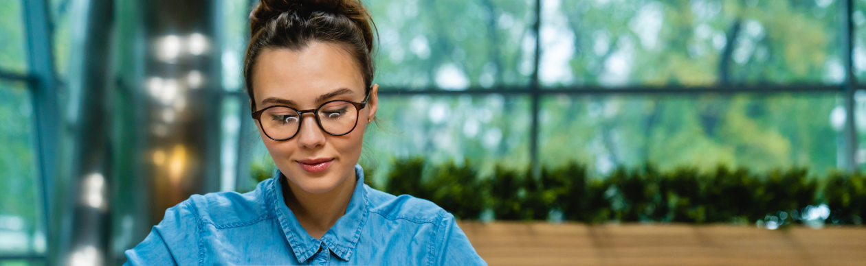 Woman wearing glasses using her Tablet