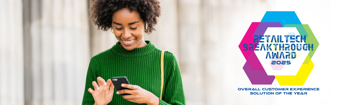 A woman smiling at her phone