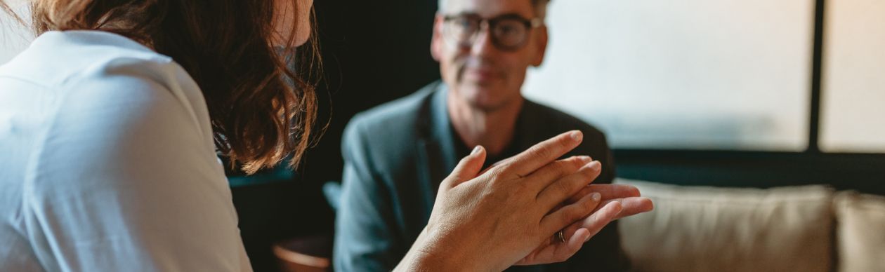 A woman talking about AI in customer service with an executive