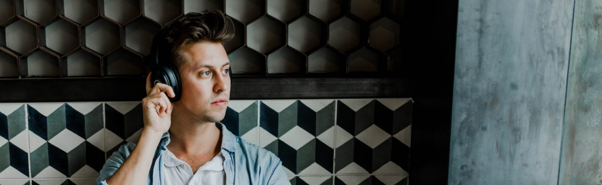 Man wearing headphones looking out a window