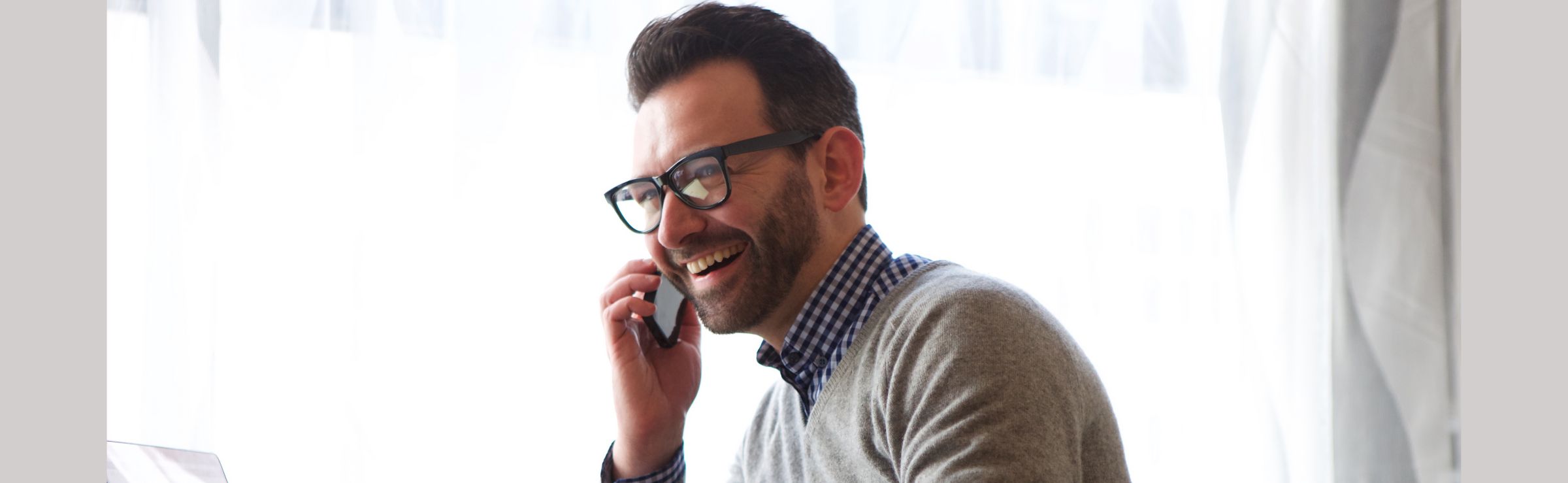 Man speaking with AI voice agent on phone