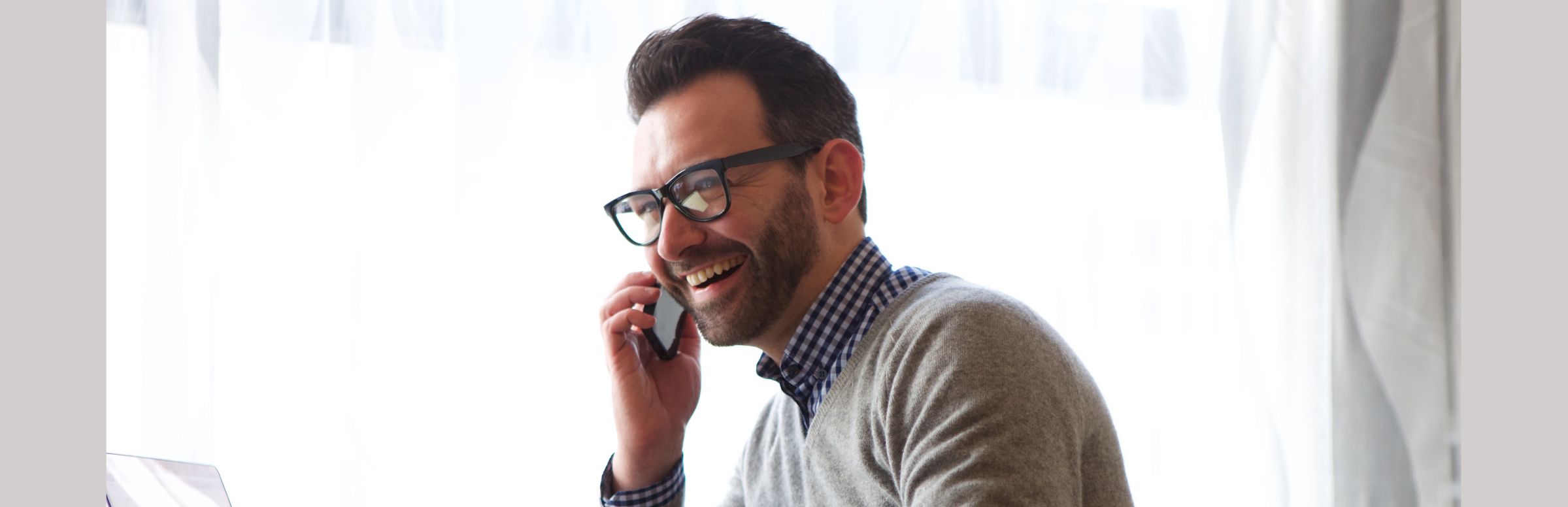 Man speaking with AI voice agent on phone