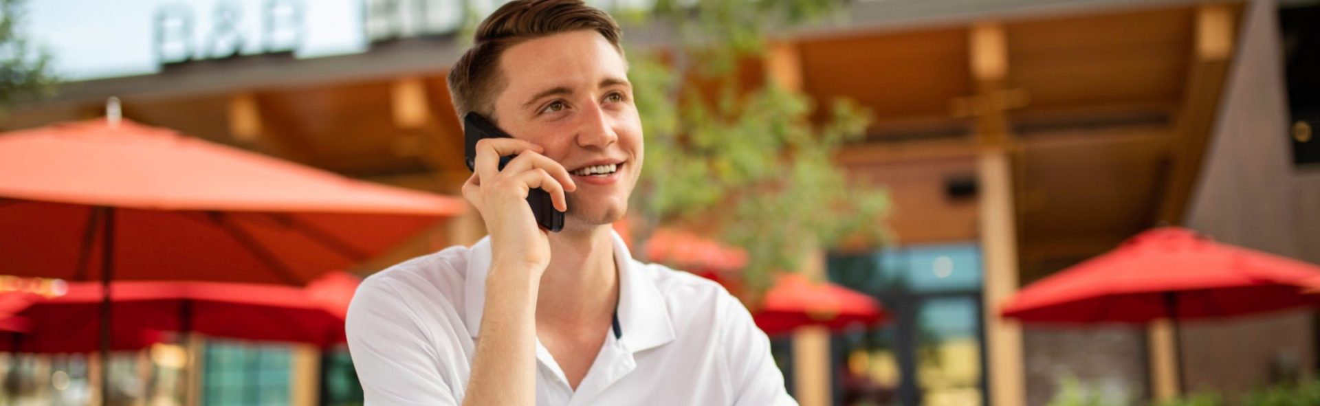 Man speaking on the phone outdoors