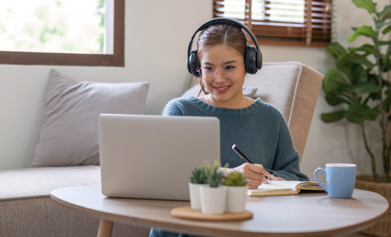 Woman taking notes off the information from her laptop