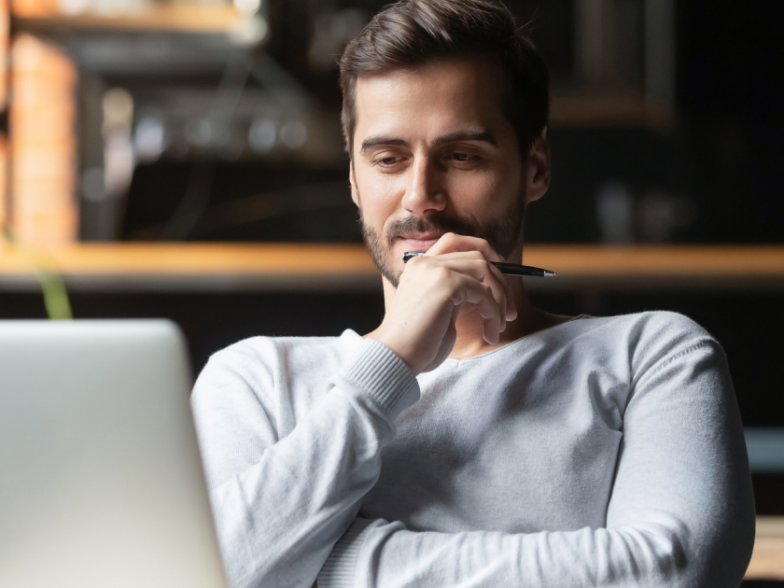 Man looking at computer, thinking