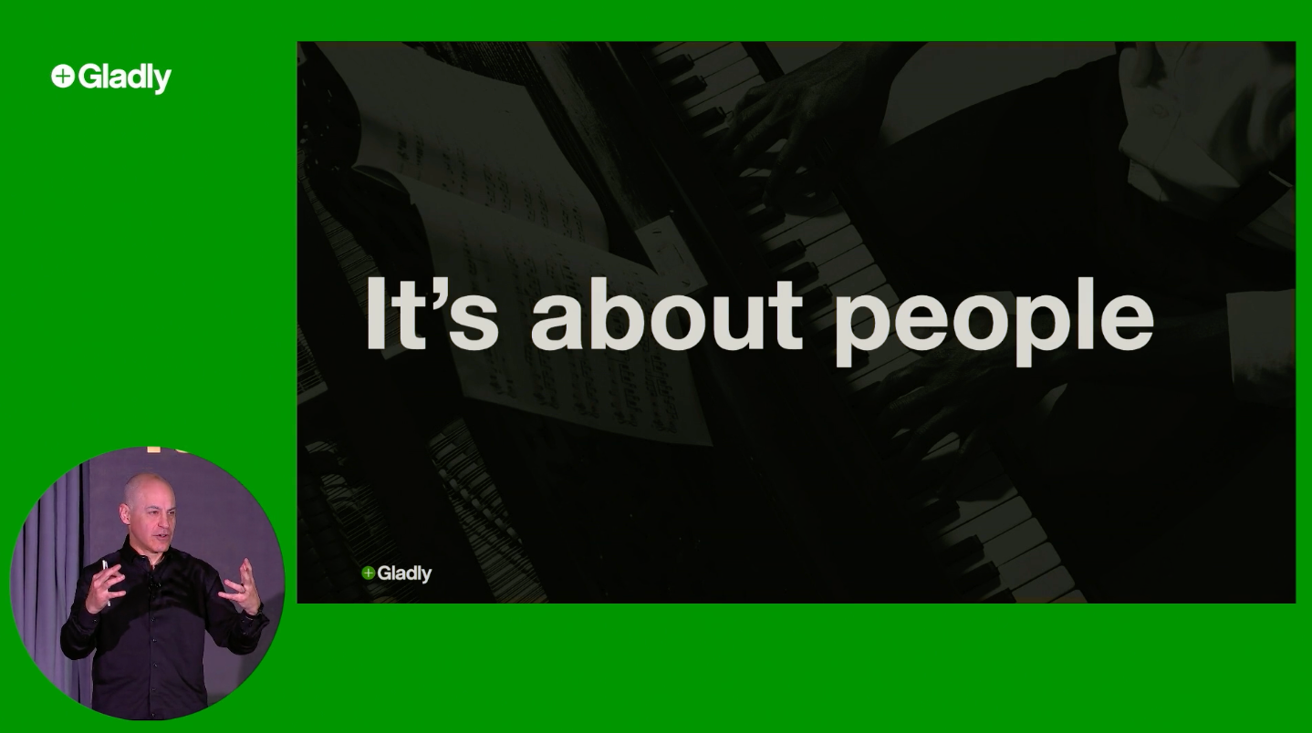 Joseph Ansanelli giving a presentation next to a slide that reads "It's about people"