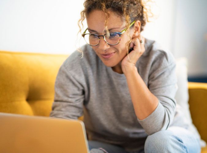Woman on laptop smiling