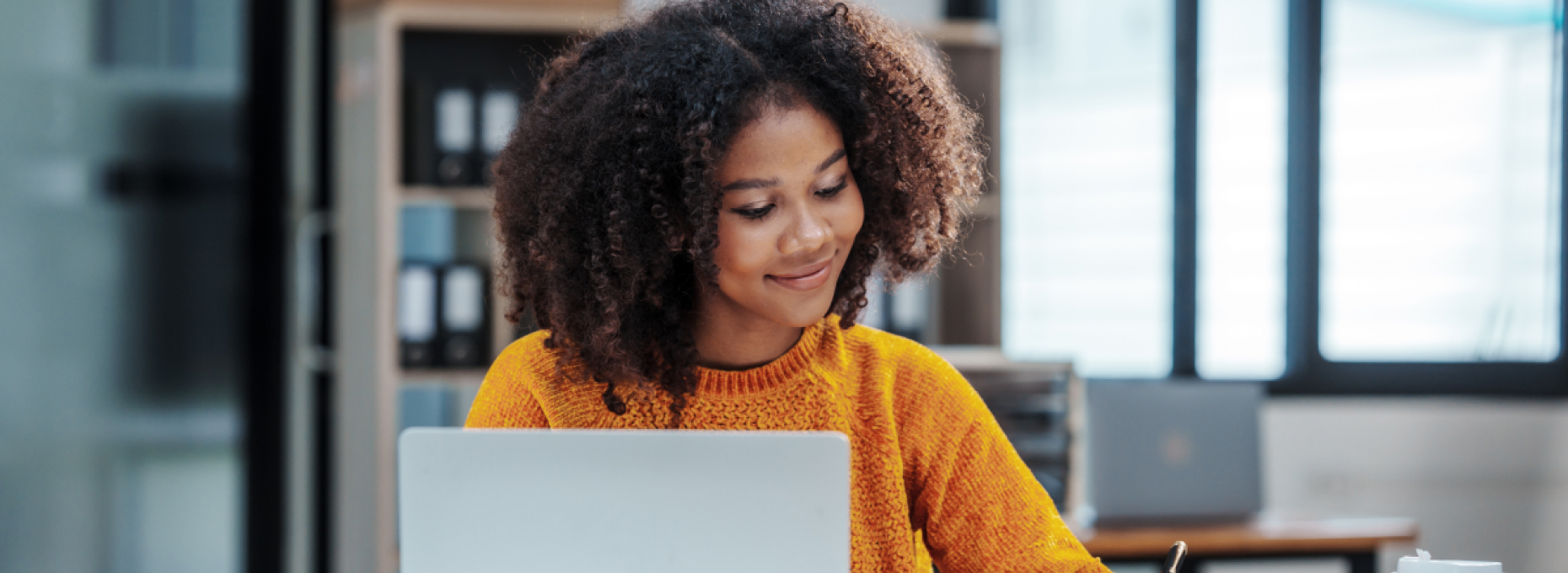 Woman working contentedly on her laptop