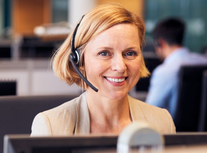 Customer service agent with headset looking at camera