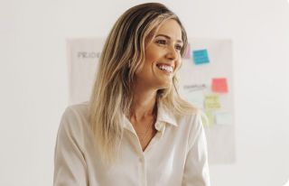 Woman in a white blouse smiling in an office