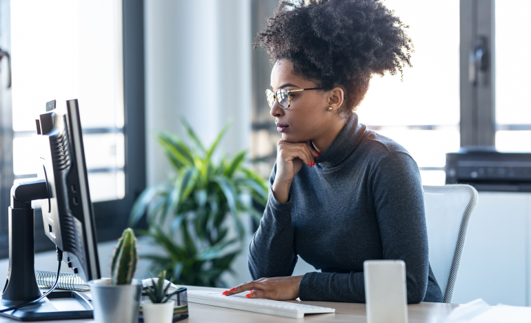 Woman with glasses using her computer