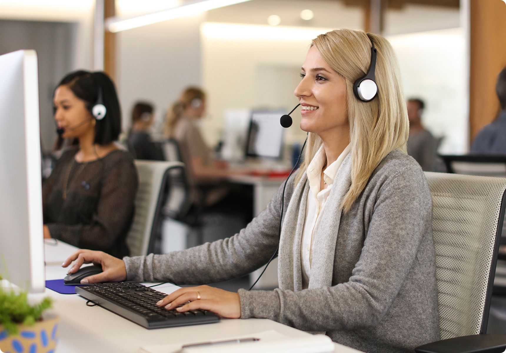 Woman working on the computer with a headset on