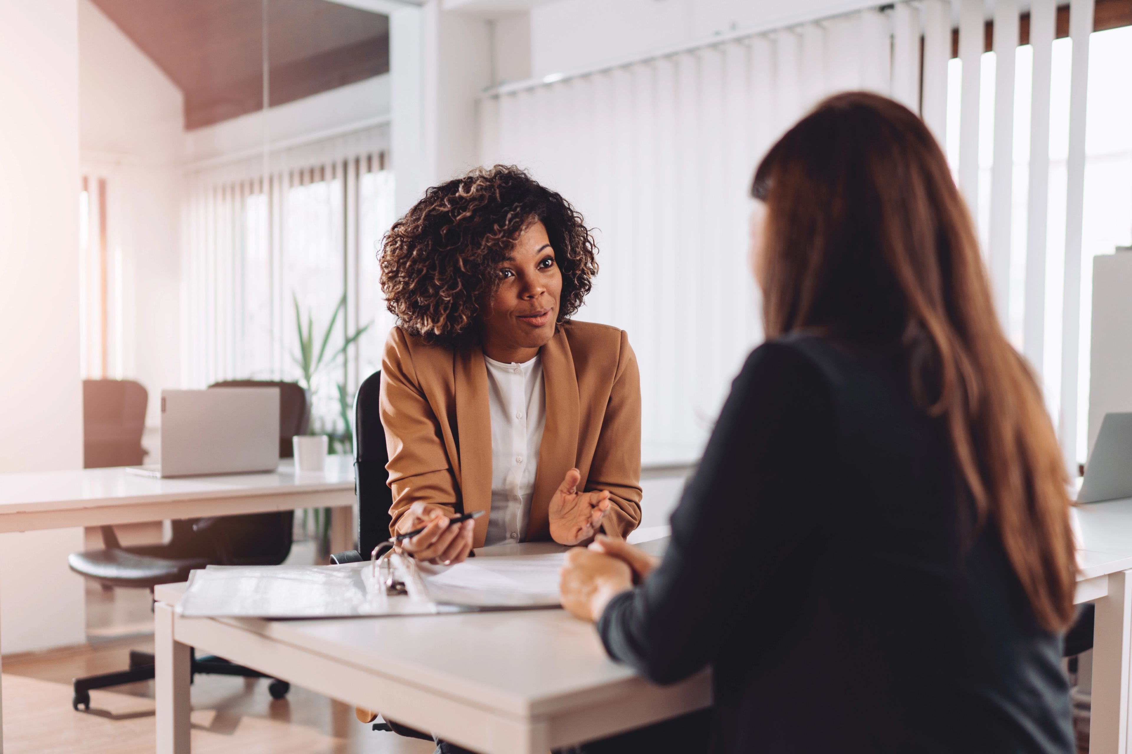 Two women sitting across the table in an interview