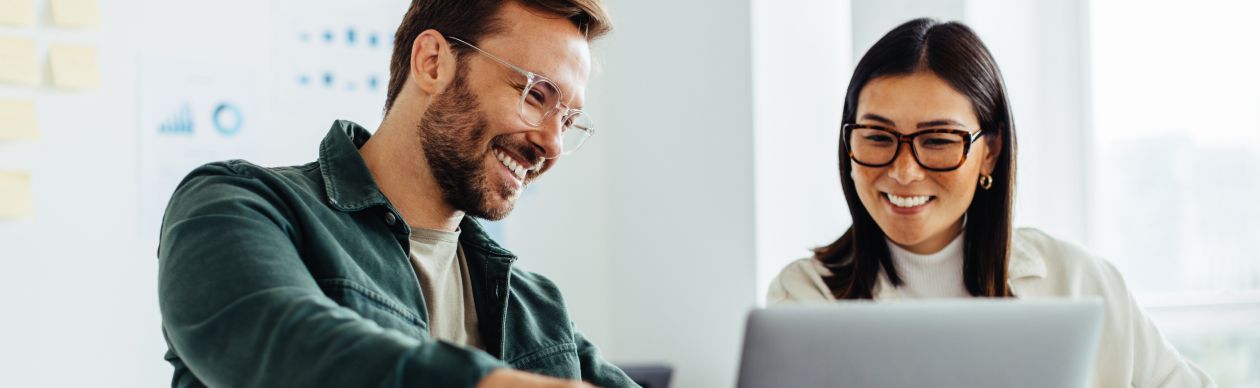 CX experts discussing AI for Better Customer Interactions on their laptop