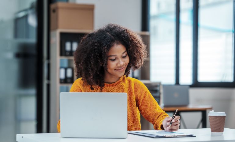 A passionate CX practitioner at her laptop reaping the benefits of attending Gladly Connect Live