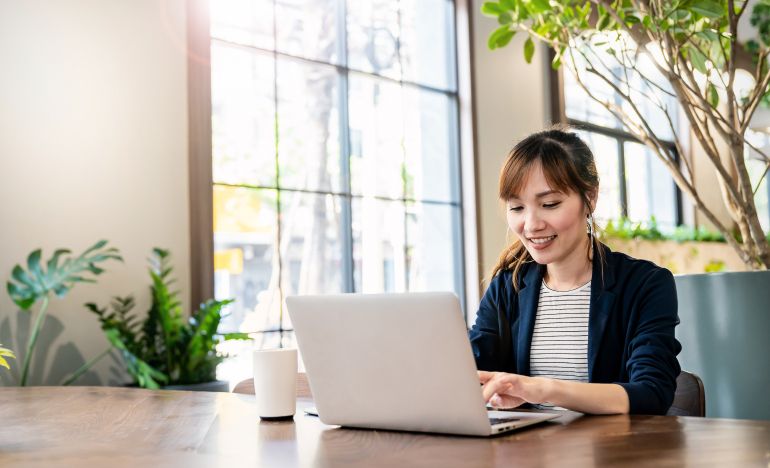 Woman working on a laptop in an office
