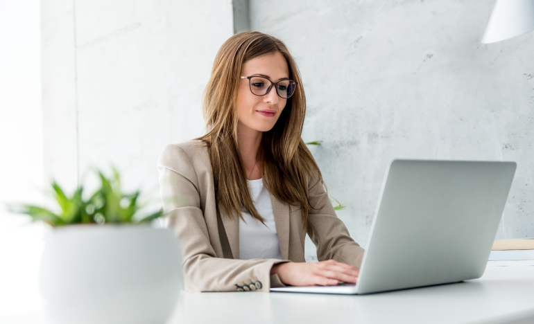 Woman wearing glasses using a laptop