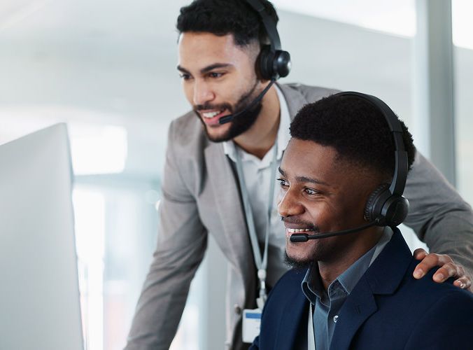 Two customer experience agents training an AI