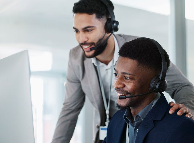 Two customer experience agents training an AI