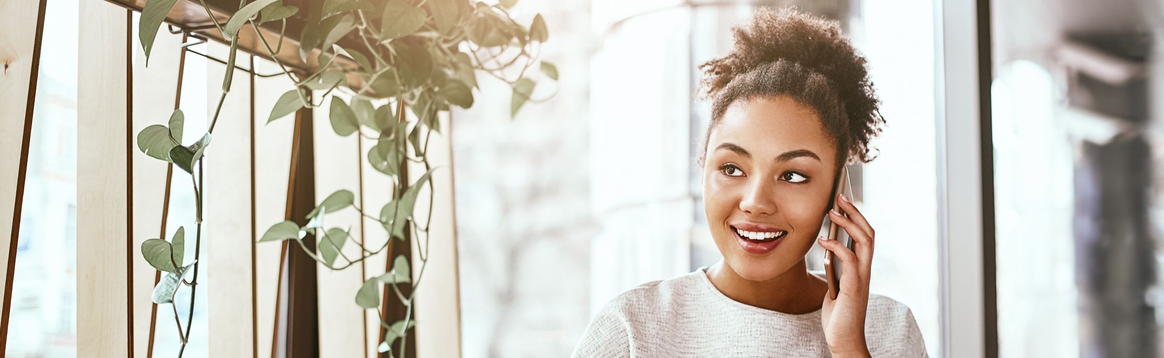 Woman on her phone at a coffee shop for SMB