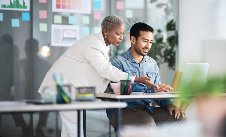 CX experts implementing AI for business at the computer