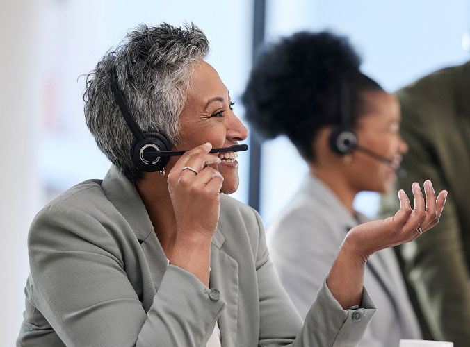 Older lady with headset working at call center