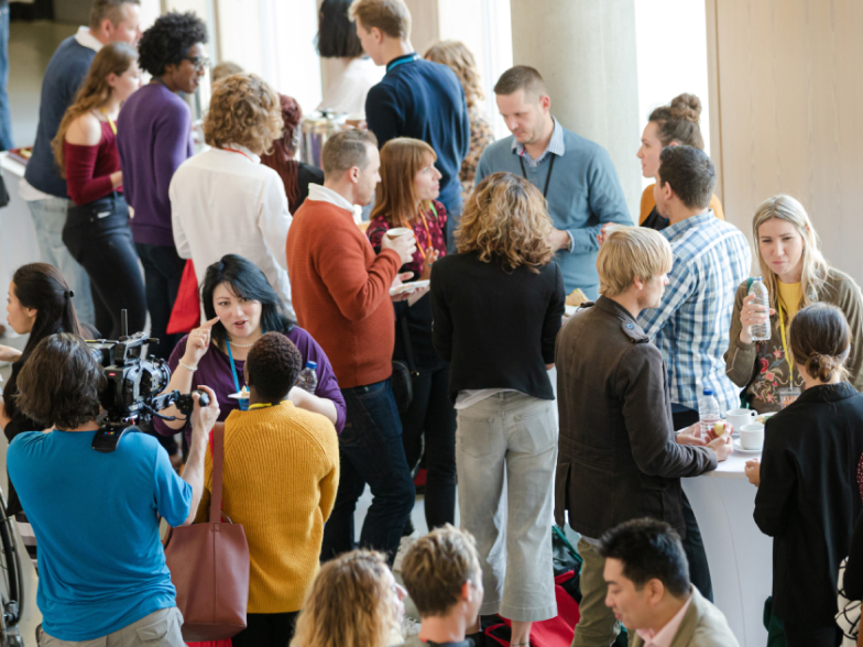 CX and retail professionals in conversation at a modern conference setting