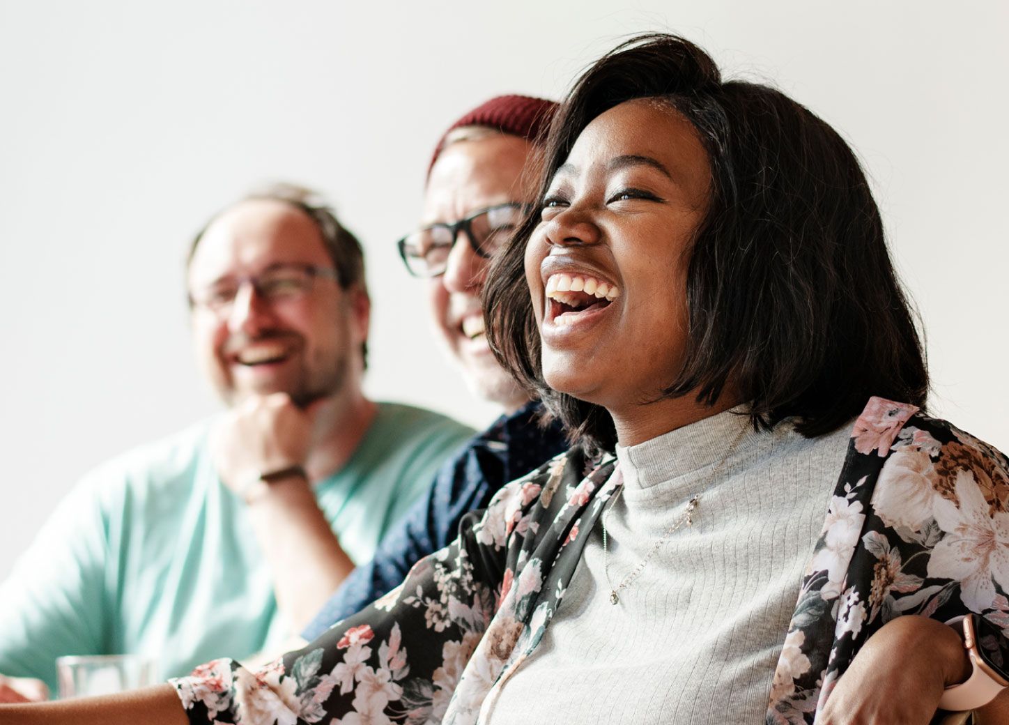 Three people smiling