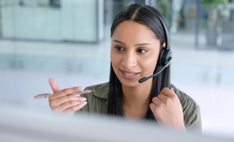 An image of a contact center rep talking on the phone