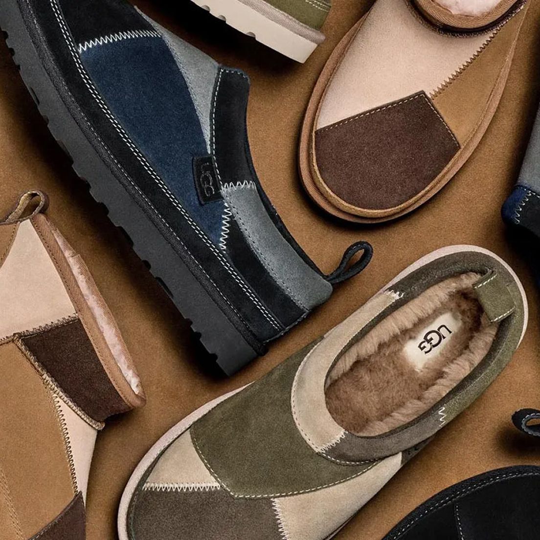 A collection of stylish UGG slip-on shoes on a brown background. Each pair features suede, patchwork designs in earthy tones, with visible stitching.