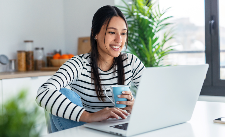 Woman smiling while using laptop