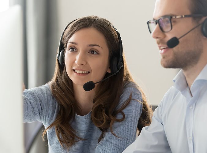Customer support agent reviewing computer together