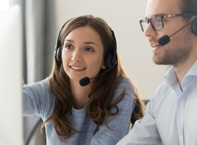 Customer support agent reviewing computer together