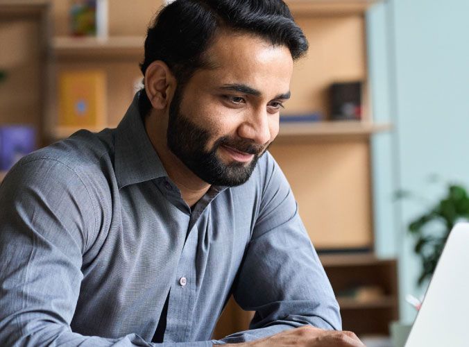 Man smiling at laptop