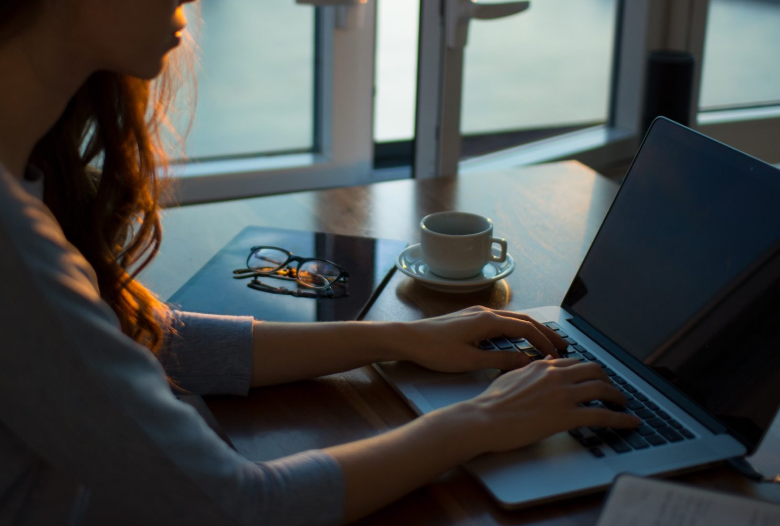 Woman typing on a laptop