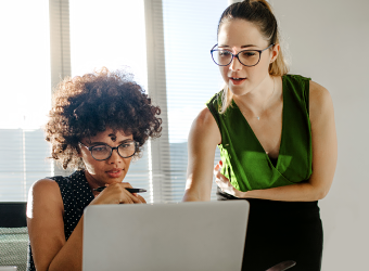 Two women looking at computer screen