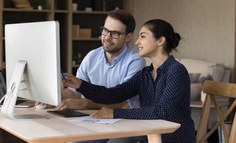 CX experts researching AI innovations at Gladly at their office computer
