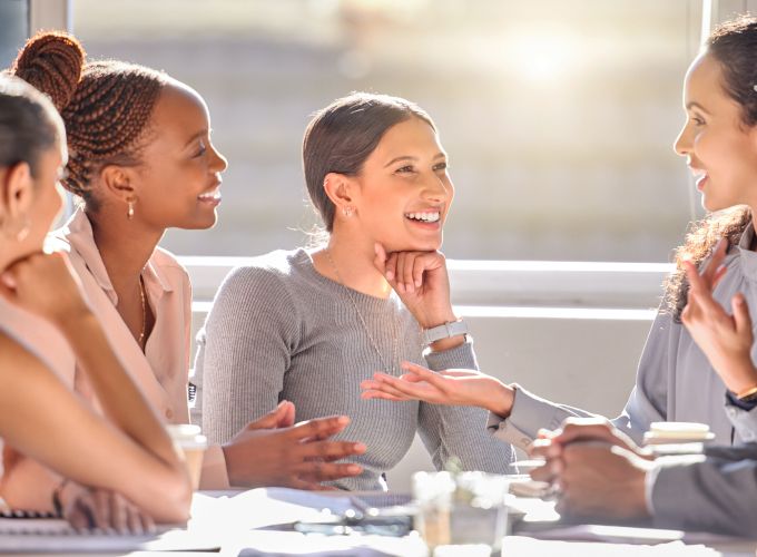 Group of five customer experience agents discussing AI