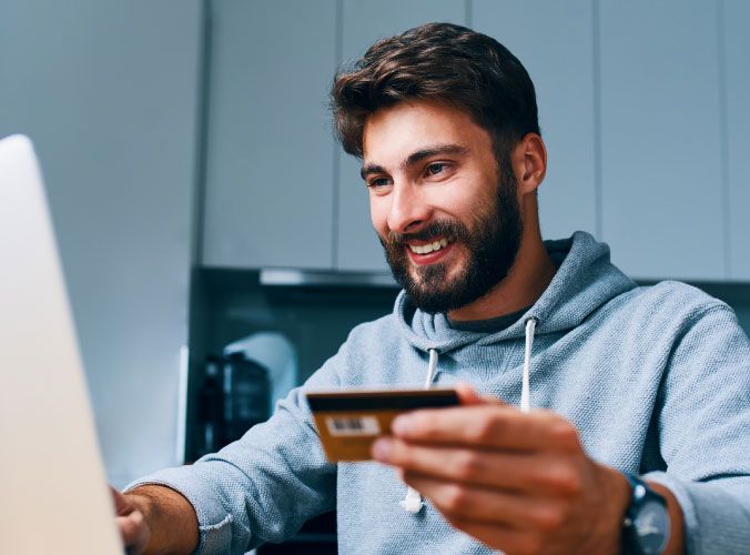 Man using credit card on laptop