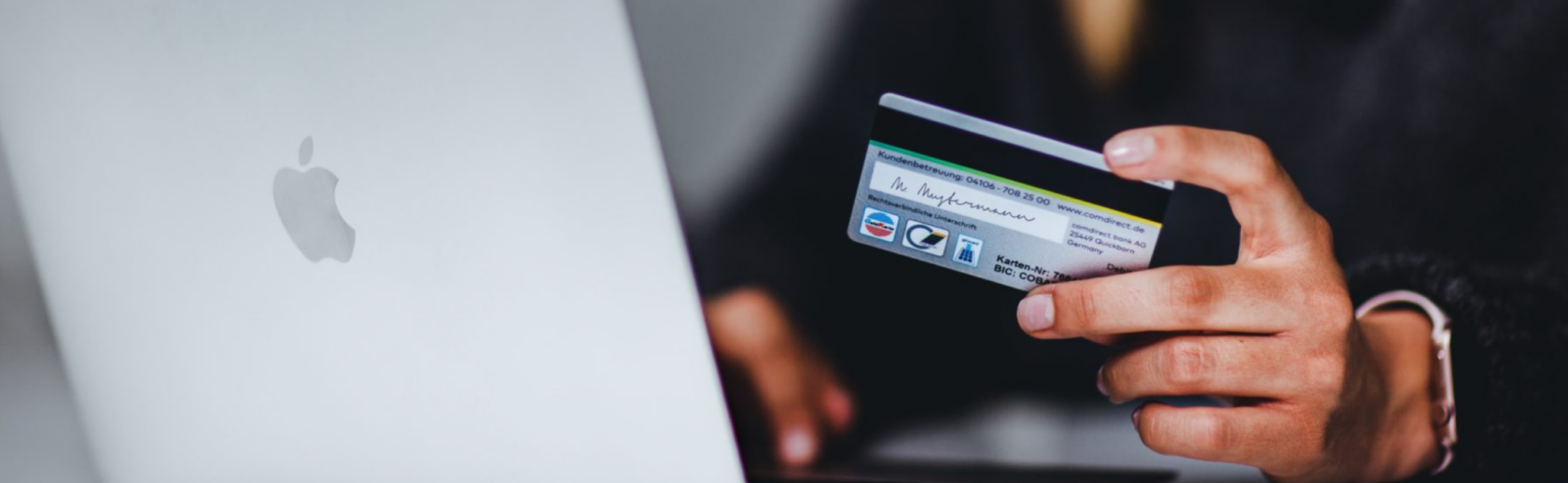 Someone preparing to enter credit card information into a laptop