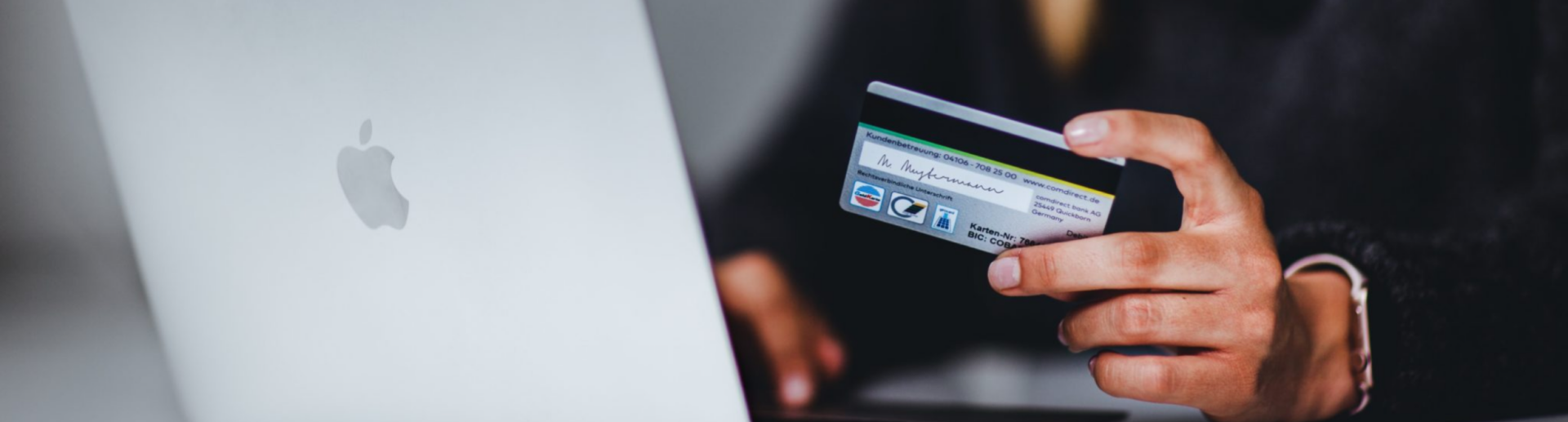 Someone preparing to enter credit card information into a laptop